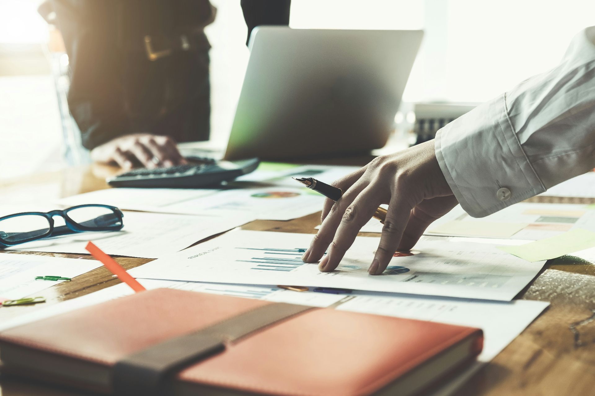 Professional investors reviewing documents in a modern boardroom discussing EB-5 regional center options