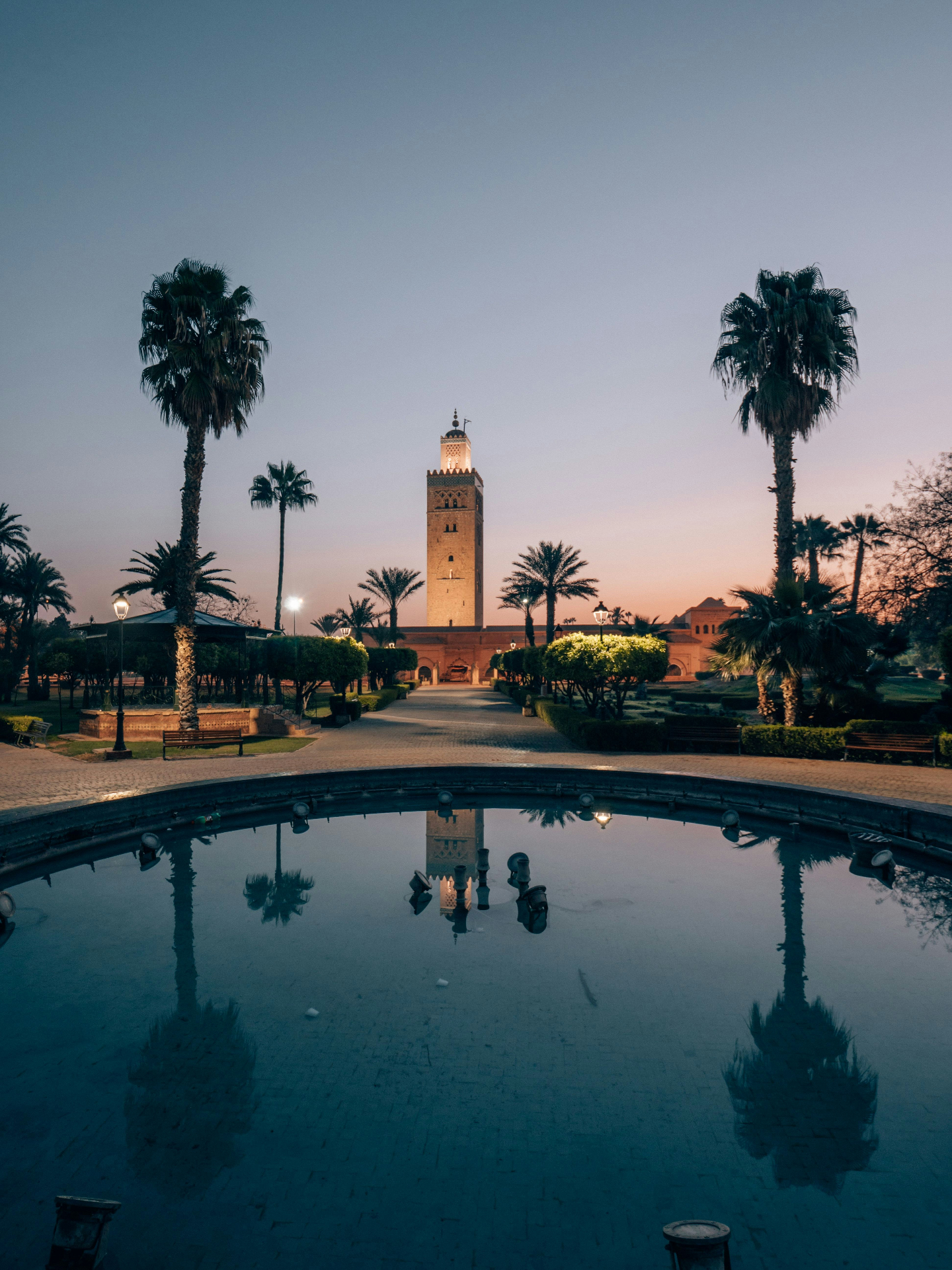 Beautiful mosque minaret reflecting in water at sunset, symbolizing global opportunities
